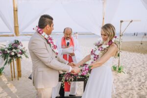 Scenic beach wedding ceremony with the waves crashing in the distance