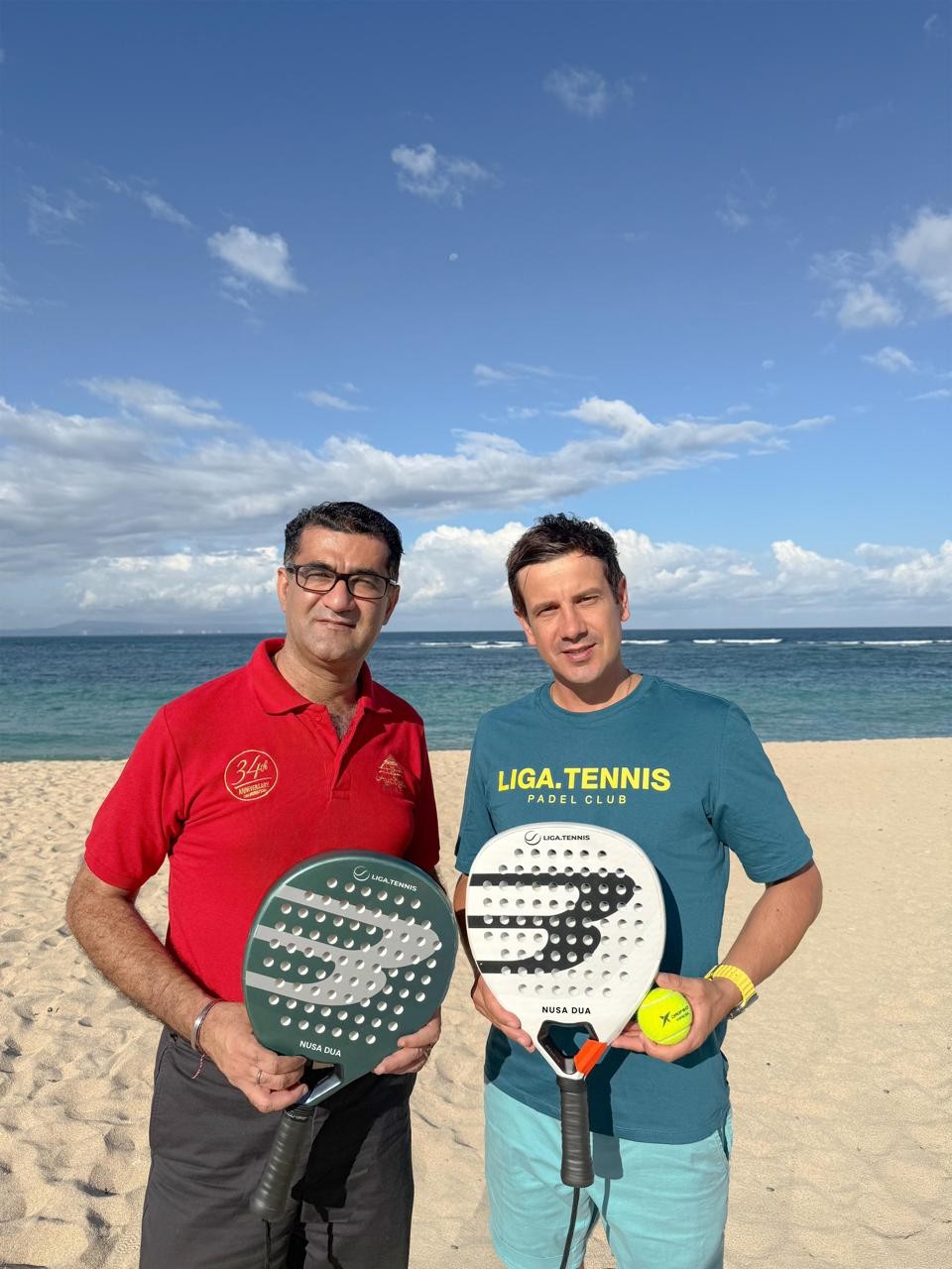 two man holding padel rackets